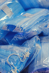 New unopened packages of medical masks in polyethylene, close-up