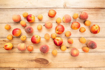 Large ripe and juicy peaches, apricots and nectarines on a wooden table. Healthy diet