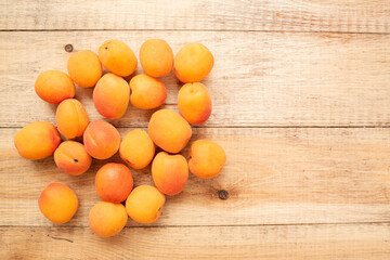Large ripe and juicy apricots on a wooden table. Healthy diet
