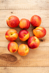 Large ripe and juicy nectarines on a wooden table. Healthy diet