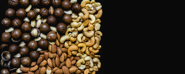 healthy food background assorted macadamia nuts, almonds, cashews, pistachios