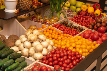 A counter with juicy and delicious vegetables and fruits. With lots of wholesome food.