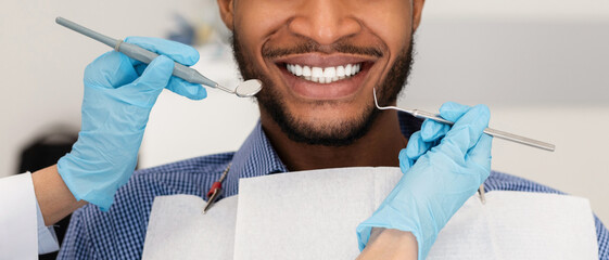 Cropped of dentist hands with tools and smiling man patient - obrazy, fototapety, plakaty