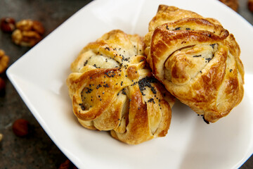 Beautiful pastries on a square white plate. Fresh aromatic pastries for breakfast or snack.