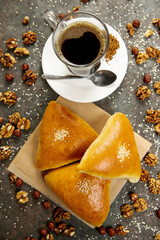 Breakfast. Fresh pastries on a white plate and a cup of coffee