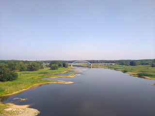 Beautiful field scenery with river and bridge. Poland.
