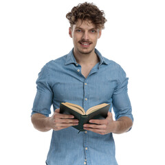smiling young casual guy in denim shirt reading book