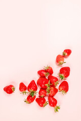 Top view organic tasty strawberry berries with copyspace on pink background, minimal composition