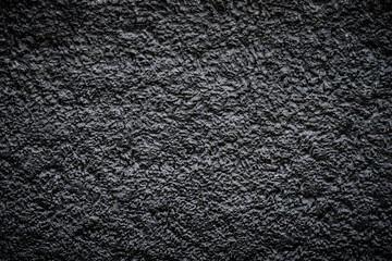 Black rough texture with vignetting at the corners. Light center frame.