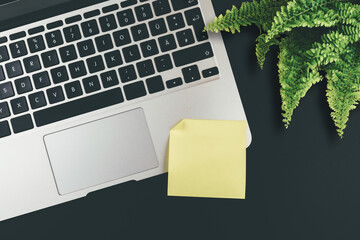 above view of empty yellow adhesive note on laptop keyboard