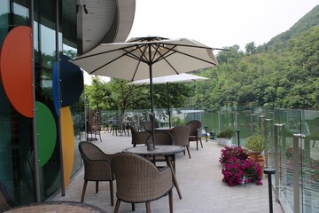 umbrella table and chairs on a lakeside terrace