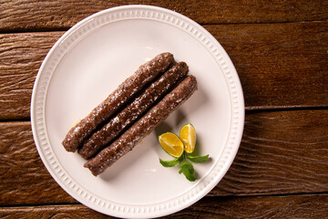 Traditional meat kafta from Arab cuisine on a white plate