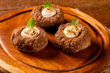 kibe stuffed with dry curd on wood background.