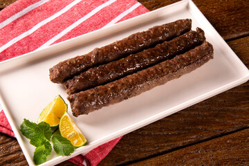 Traditional meat kafta from Arab cuisine on a white plate