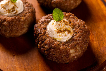 kibe stuffed with dry curd on wood background.