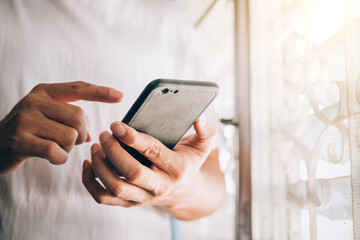 close up the hand of a young man holding a smartphone