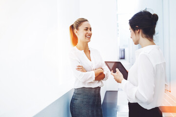 Fototapeta premium Confident businesswoman dressed in corporate clothes posing in hallway of big company