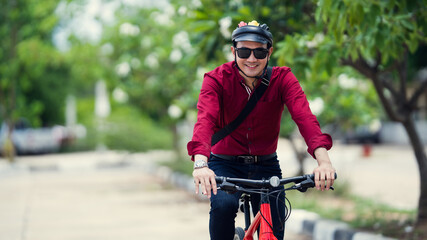 Asian men ride bicycles to work. Take the park path