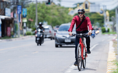 Asian men ride bicycles to work. During a traffic jam