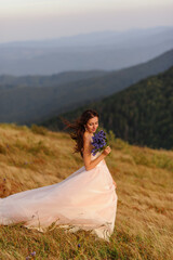 Portrait of a beautiful bride with a bouquet of wildflowers 