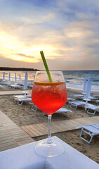 Cocktail Aperol Spritz on the background of evening beach