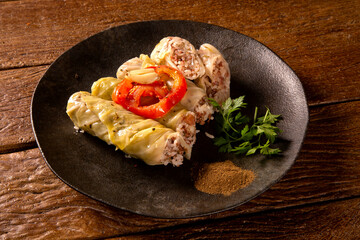 Arabic food. Appetizing cabbage rolls on wood background