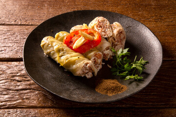Arabic food. Appetizing cabbage rolls on wood background
