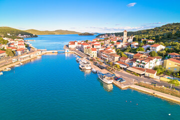 Coastal town of Tisno aerial panoramic view, bridge to island of Murter