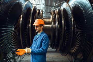 Engineer checks turbine impeller vanes, factory