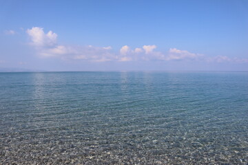 Fototapeta premium sea and sky. Seascape. Calm. The clear blue sea. Sunny morning. Clouds are reflected in the water Transparent sea water. Blue sky. Summer. Holidays at sea. Silence. 