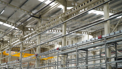 The interior of a big industrial building or factory with steel constructions