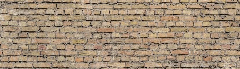 Old vintage yellow brick wall pattern. panoramic view of old brick wall.