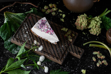 Homemade cheesecake. Slice of tasty plain cheesecake on wooden background