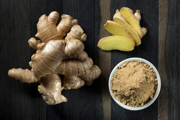 Ground ginger root in a bowl on a wooden table.