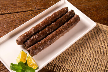 Traditional meat kafta from Arab cuisine on a white plate