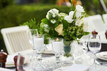 Decorated table with candles with beautiful bouquet