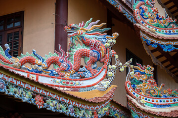Colorful dragon sculpture on the roof In a Buddhist temple in Danang, Vietnam
