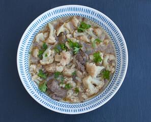 Syrian Cauliflower stew plated and served with fresh herbs