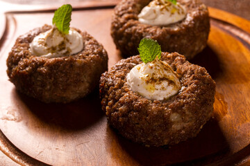 kibe stuffed with dry curd on wood background.