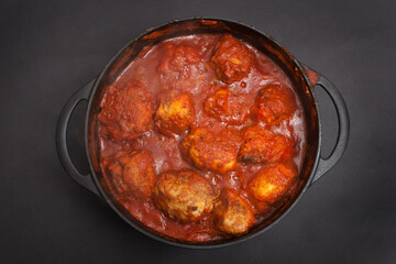A Libyan dish of stuffed potatoes with minced beef cooked in a spicy tomato sauce