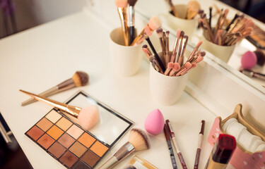 Cosmetics and makeup brushes for on table