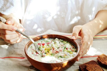 okroshka - Russian cold soup and hands. Space for text. copy space