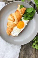 Morning Breakfast with scrambled eggs, croissant and rucola