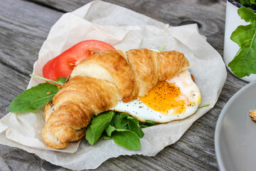 Morning Breakfast with scrambled eggs, croissant and rucola