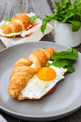 Morning Breakfast with scrambled eggs, croissant and rucola