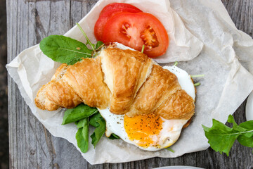 Morning Breakfast with scrambled eggs, croissant and rucola