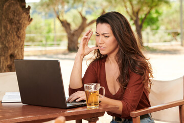 worried woman looking at a laptop