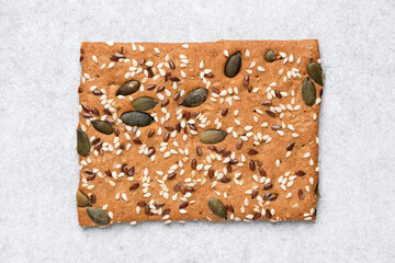 Whole grain rye crispbread cracker isolated on grey concrete background