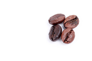four ripe coffee beans with a white background