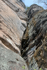 Wuyishan mountains in Fujian Province, China. On the path to DaWang (Great King) Peak. The mountain has steep cliffs and the path is inside the crack in the rock. Wuyishan is a UNESCO site in China.